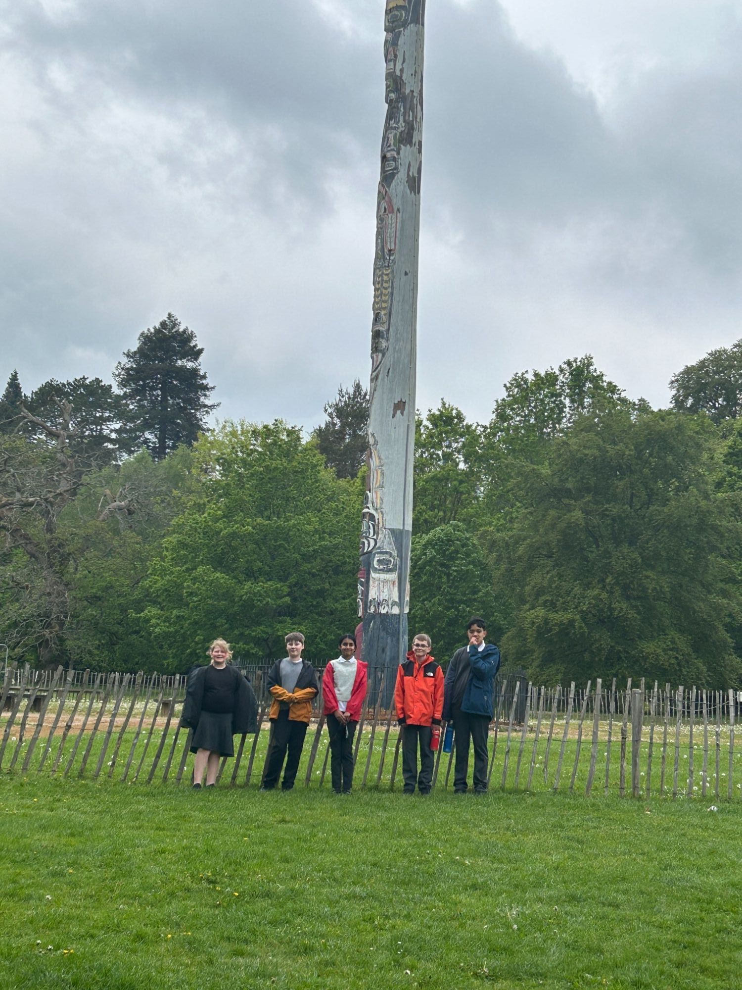 Students stood infront of the totem pole