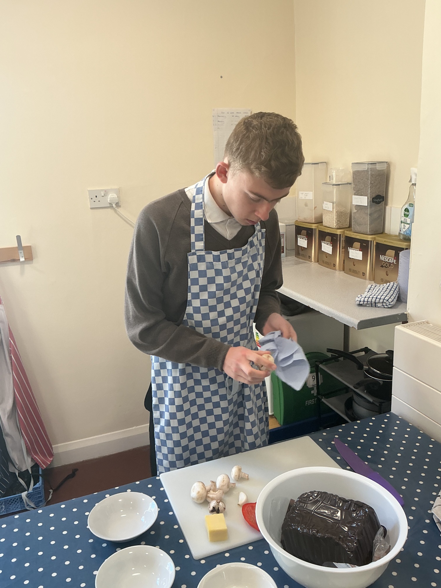 Student getting ready to cook his recipe preparing vegetables