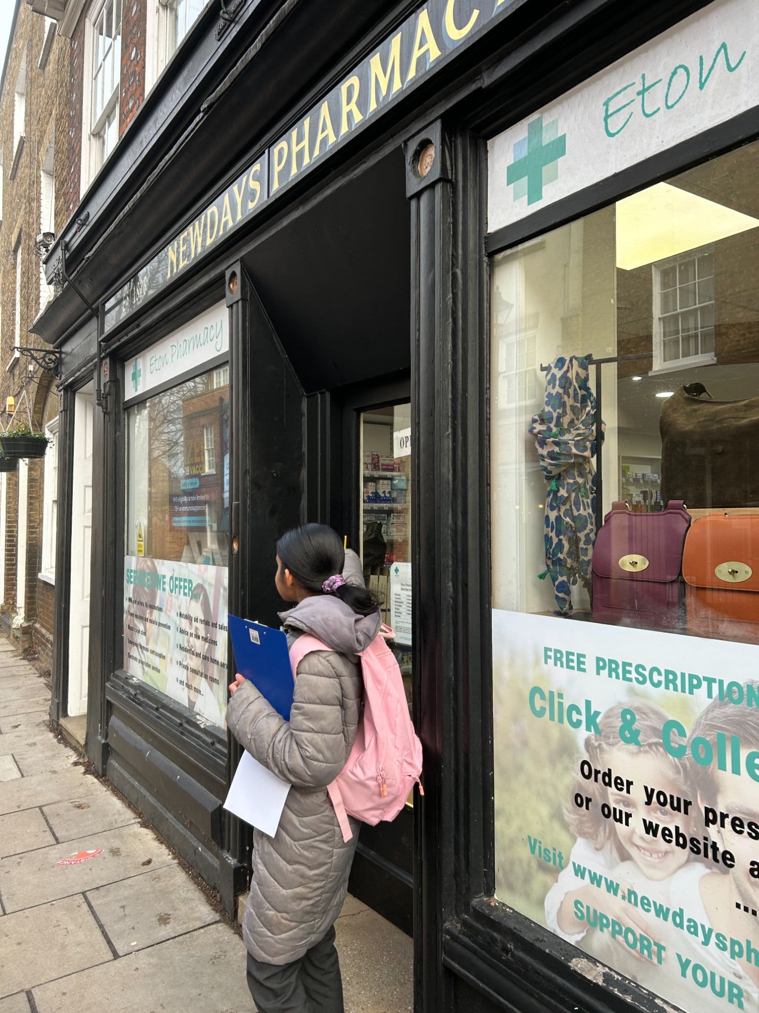 Female student outside a tradional pharmacy store