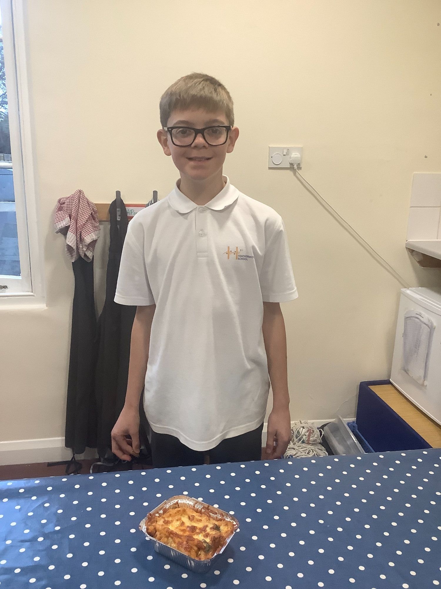 Student with the meal he has cooked