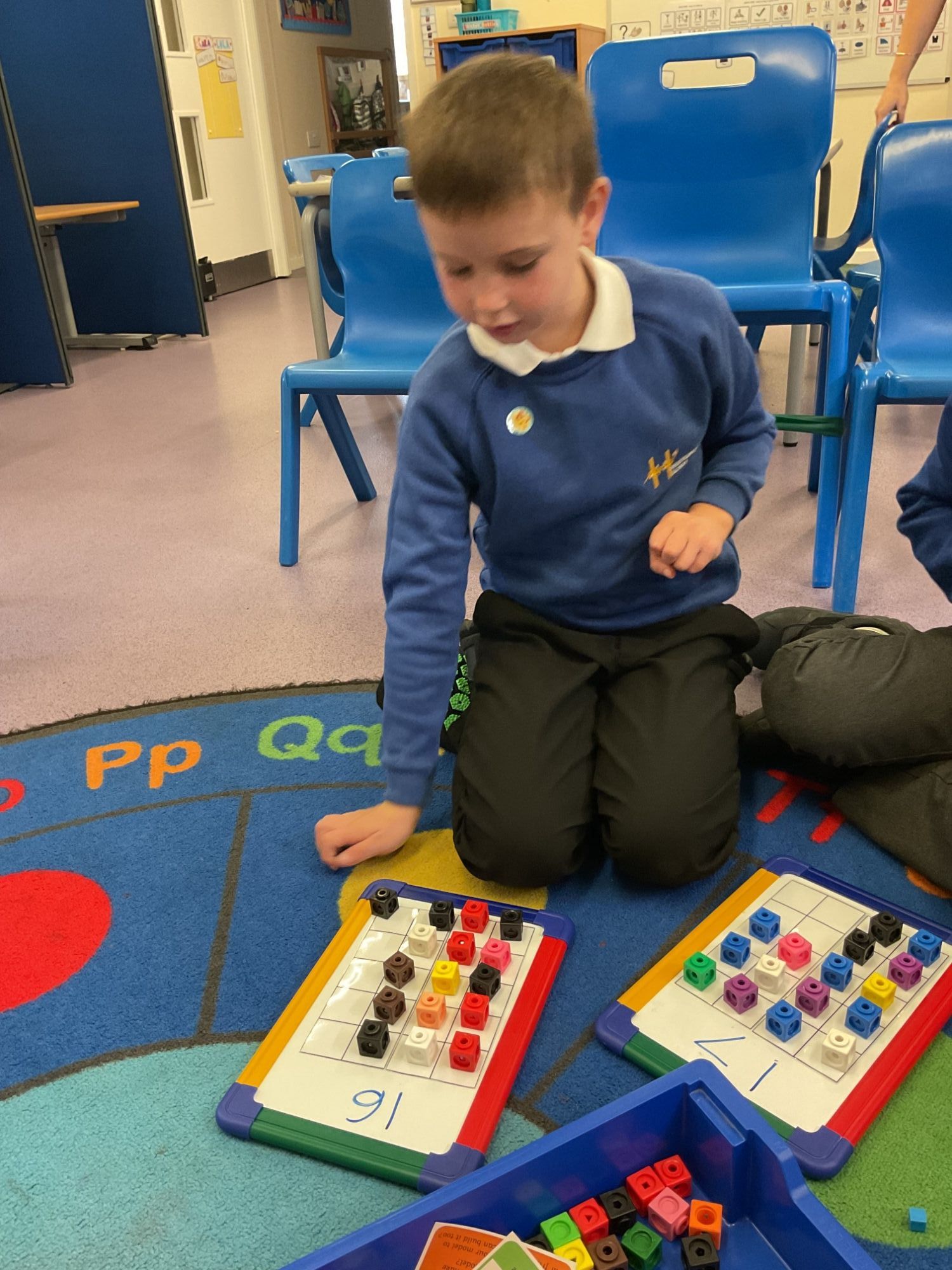 Apple student counting with blocks on a board