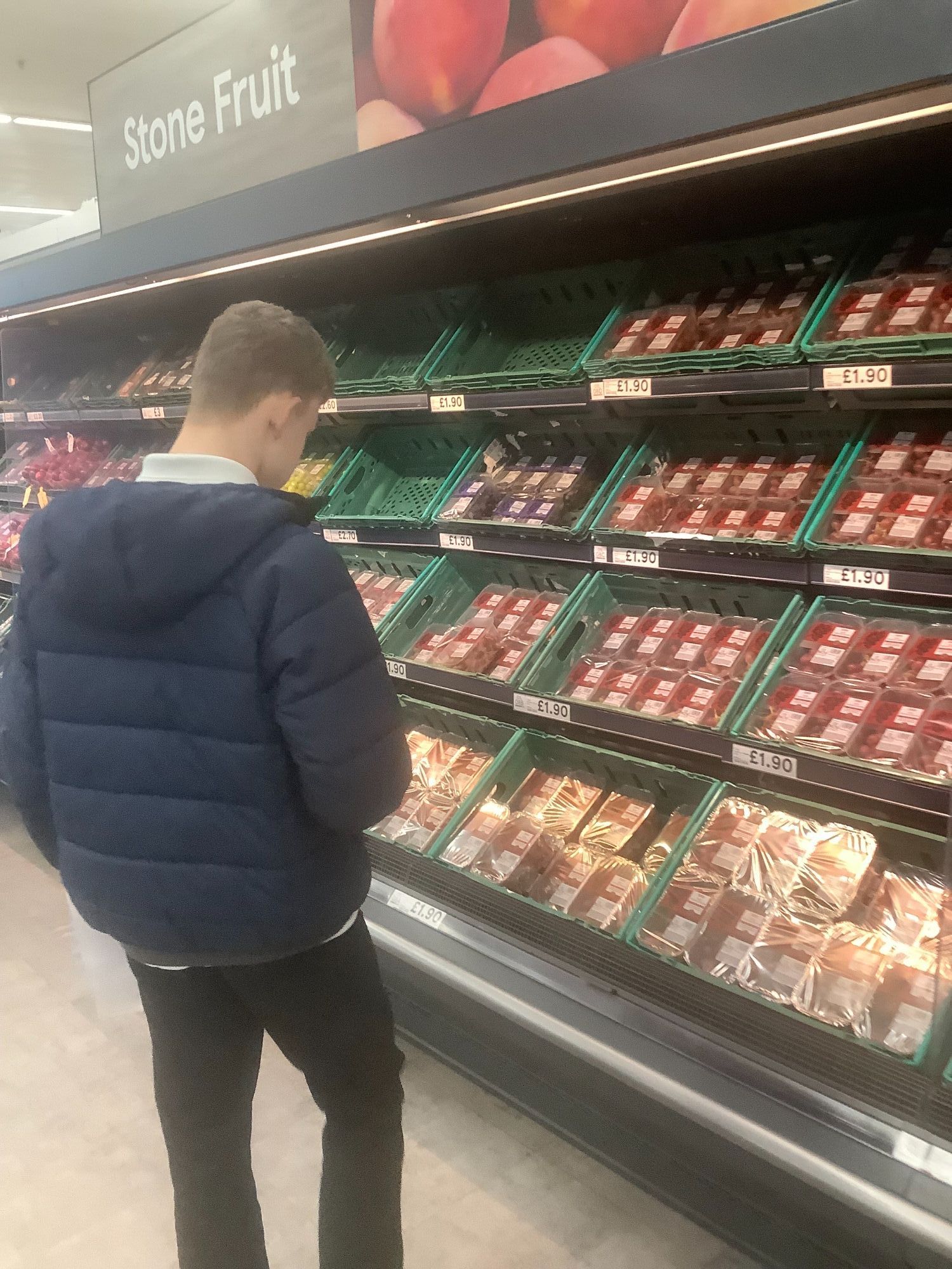 Student deciding which vegetables to buy at the supermarket