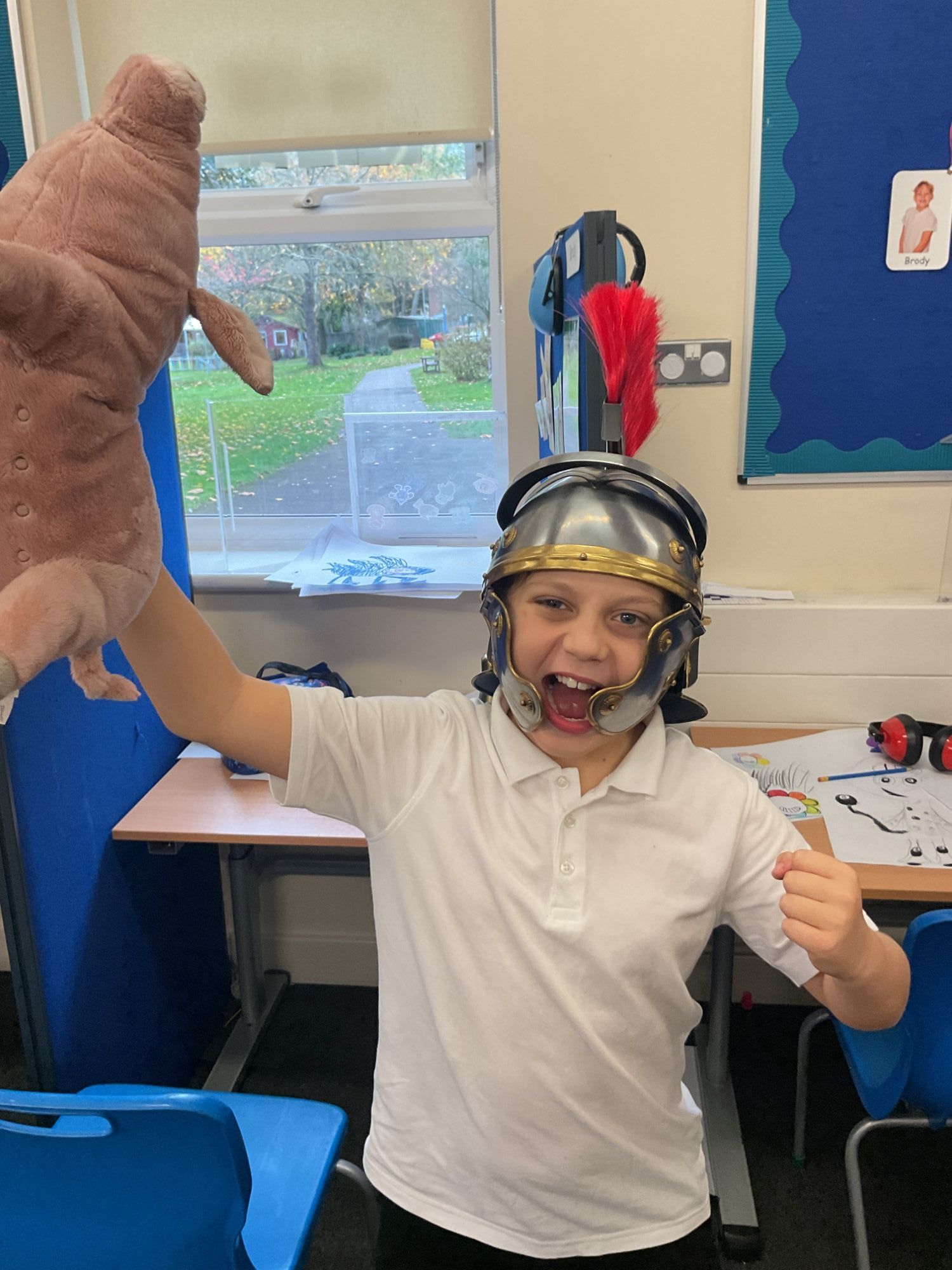 Excited student wearing a Roman helmet