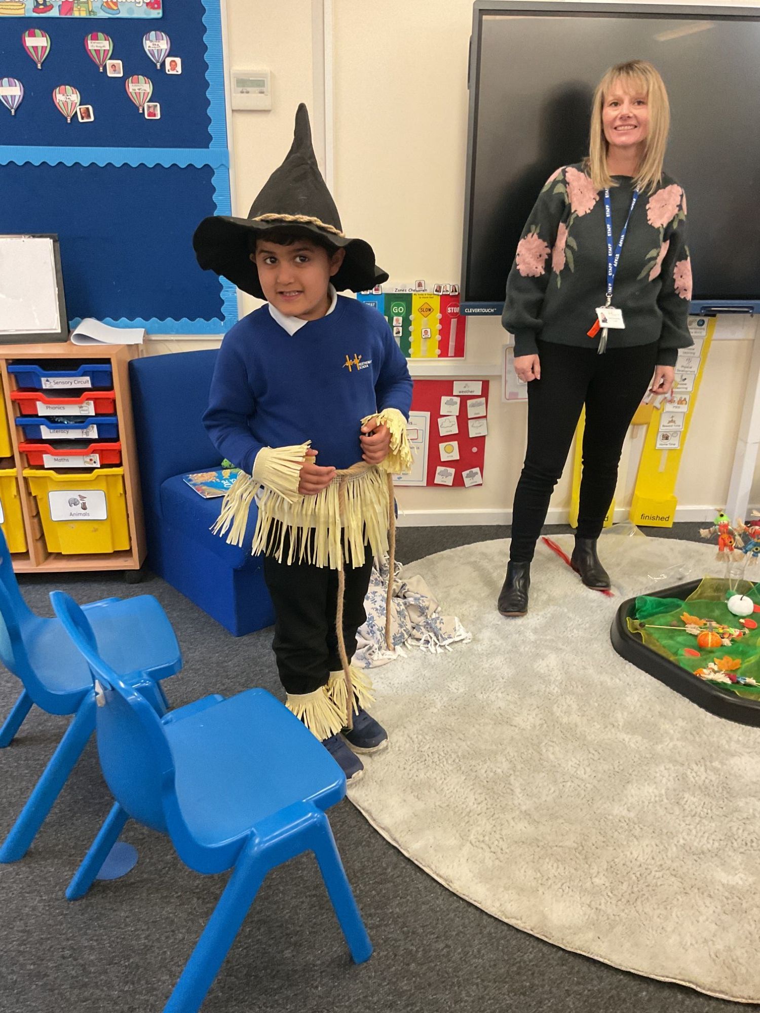 Student in scarecrow dress-up with his teacher