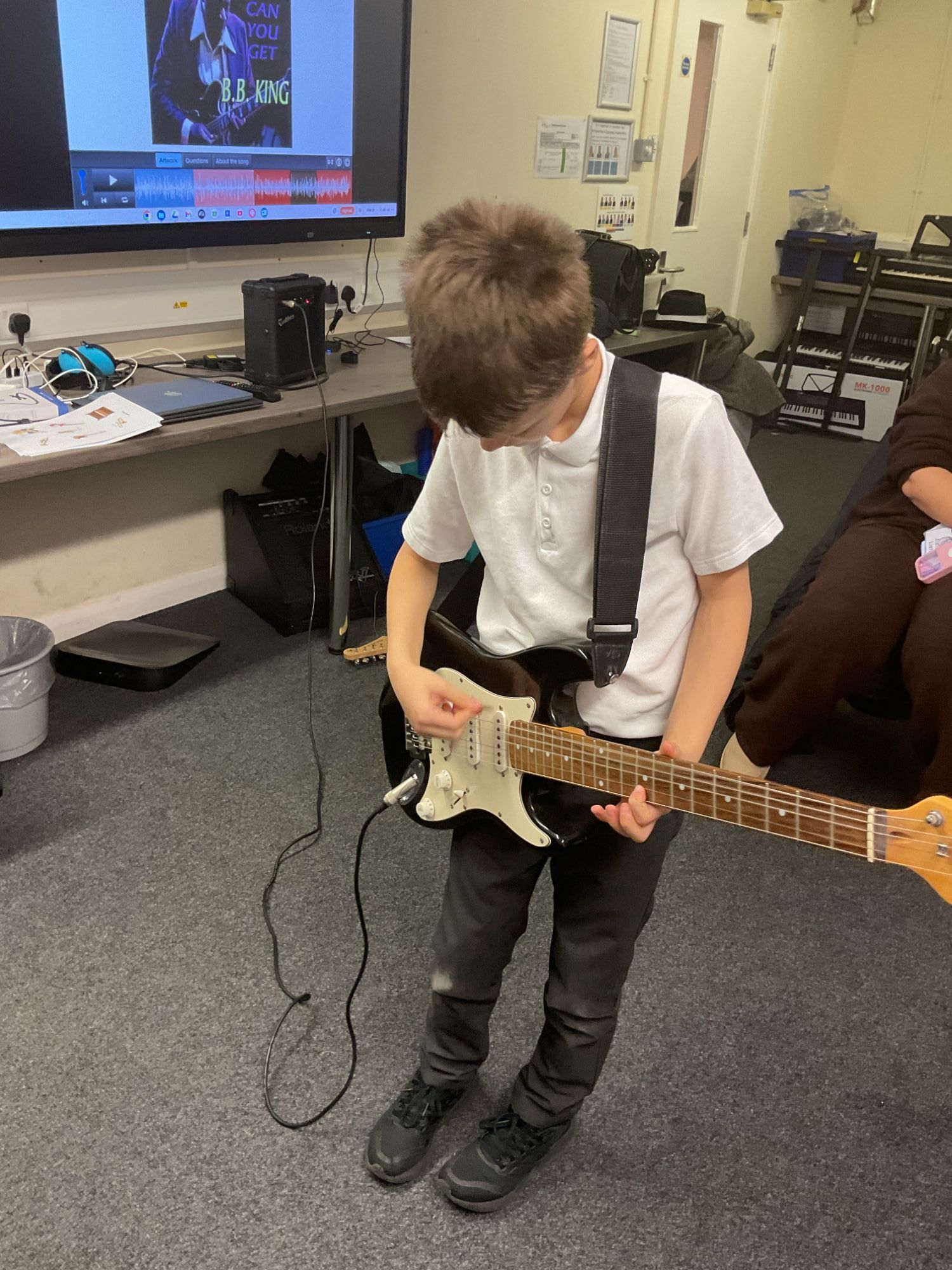 Student playing the electric guitar
