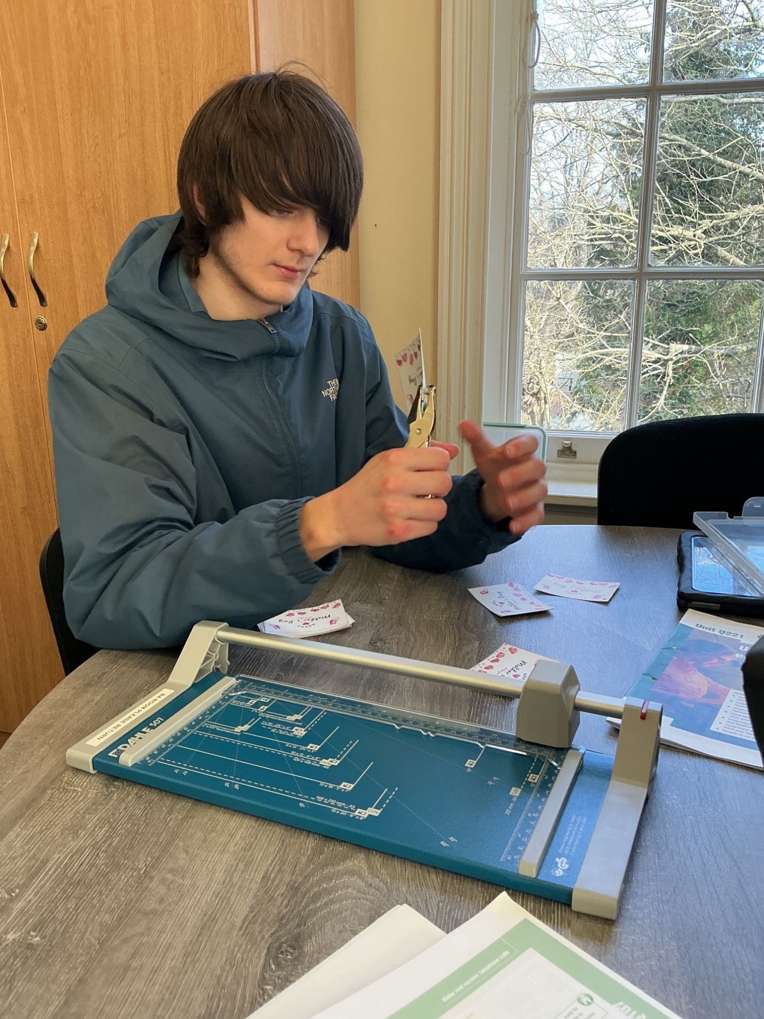 Cutting paper Student cutting paper with a guillotine