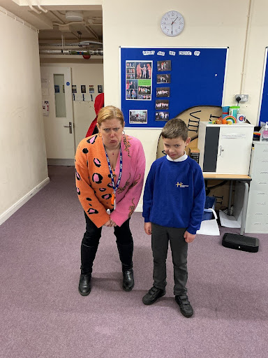 Drama teacher and student demonstrating facial expressions