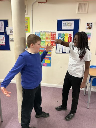 Drama gestures Two primary students practicing gestures