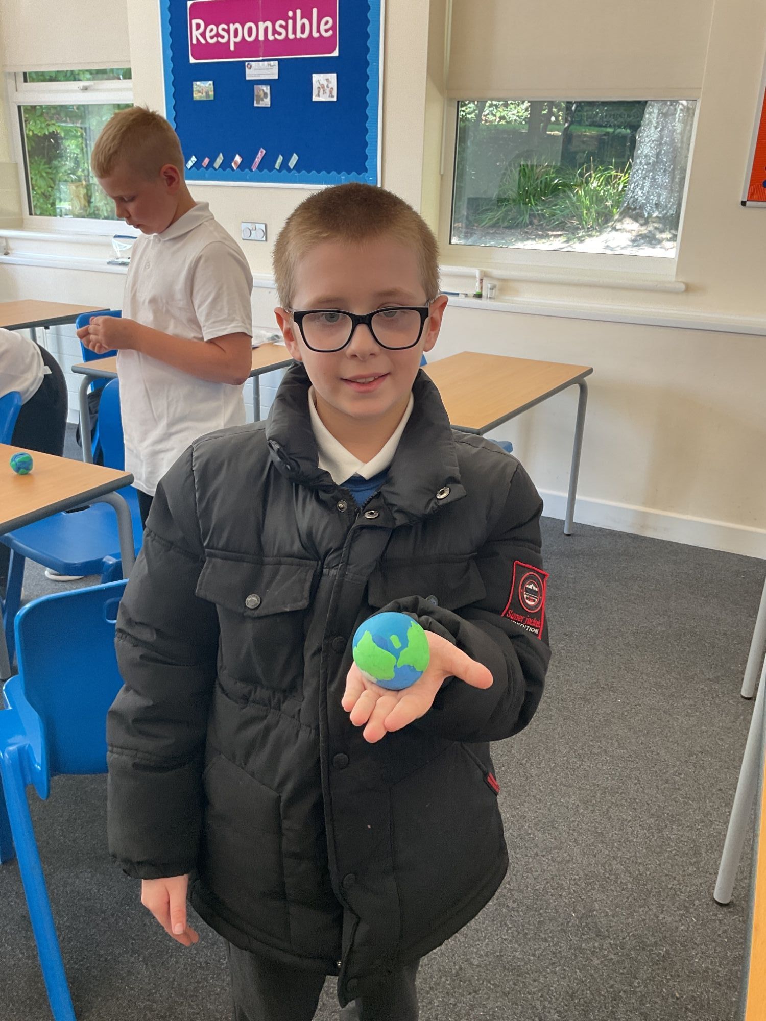 Student from Beech with his clay model of the earth