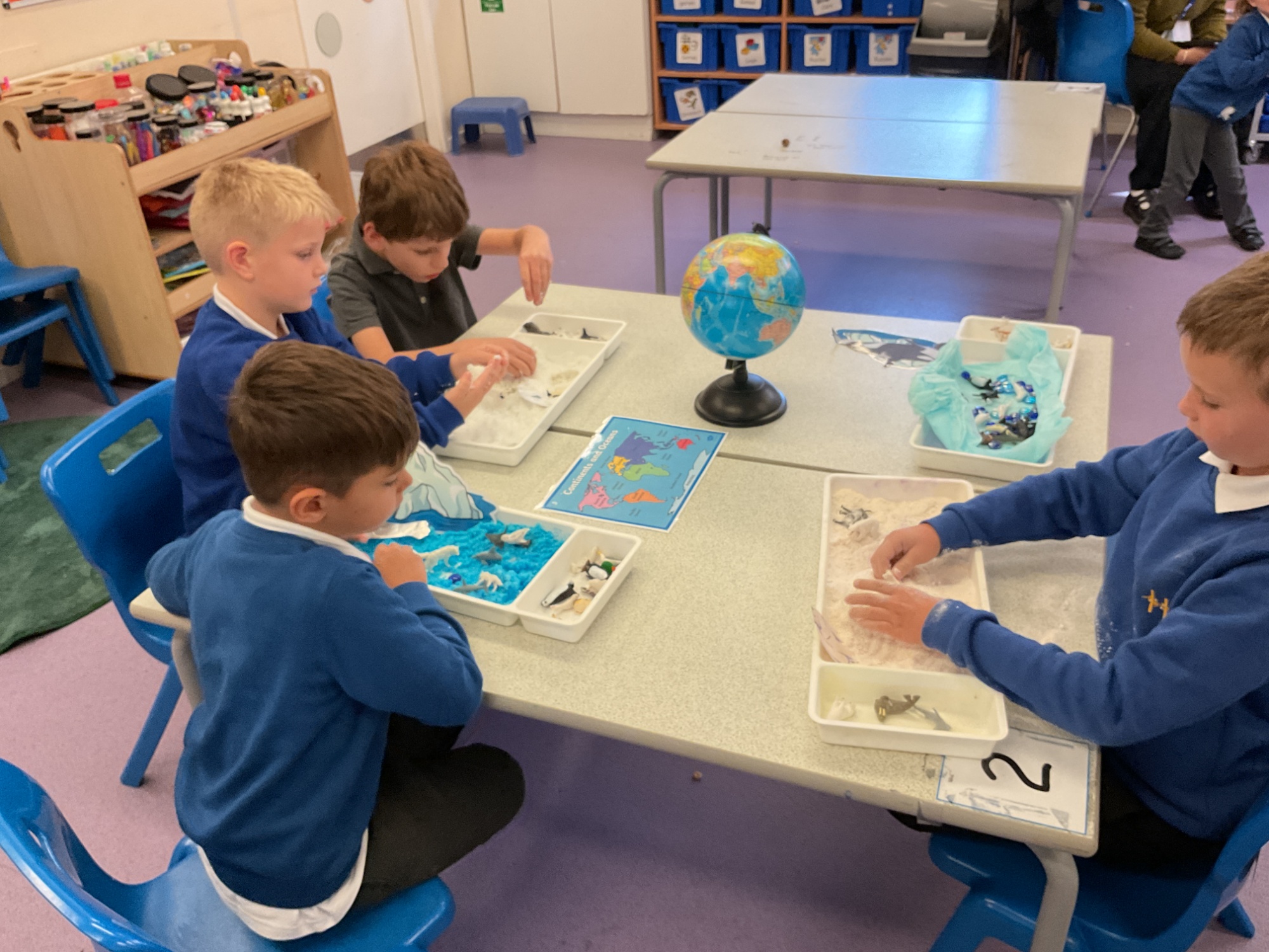 Foundation students with sensory 'snow' trays