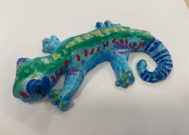 Blue and green gecko Clay gecko painted blue with a green stripe and yellow dots