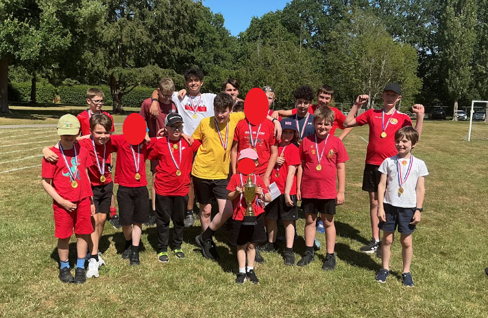 Red team celebrating with their trophy