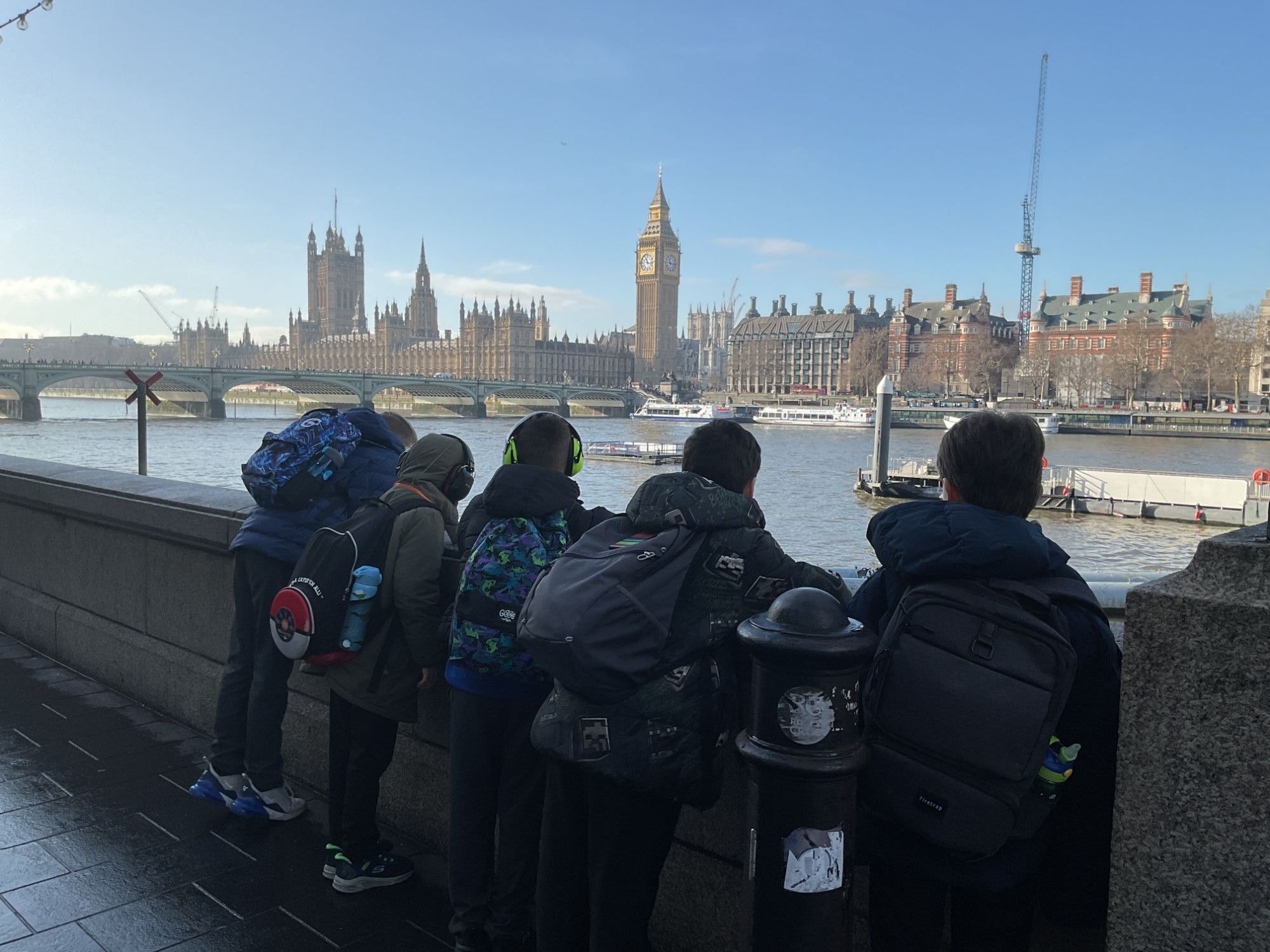 Boys looking out  over the Thames at the Houses of Parliament