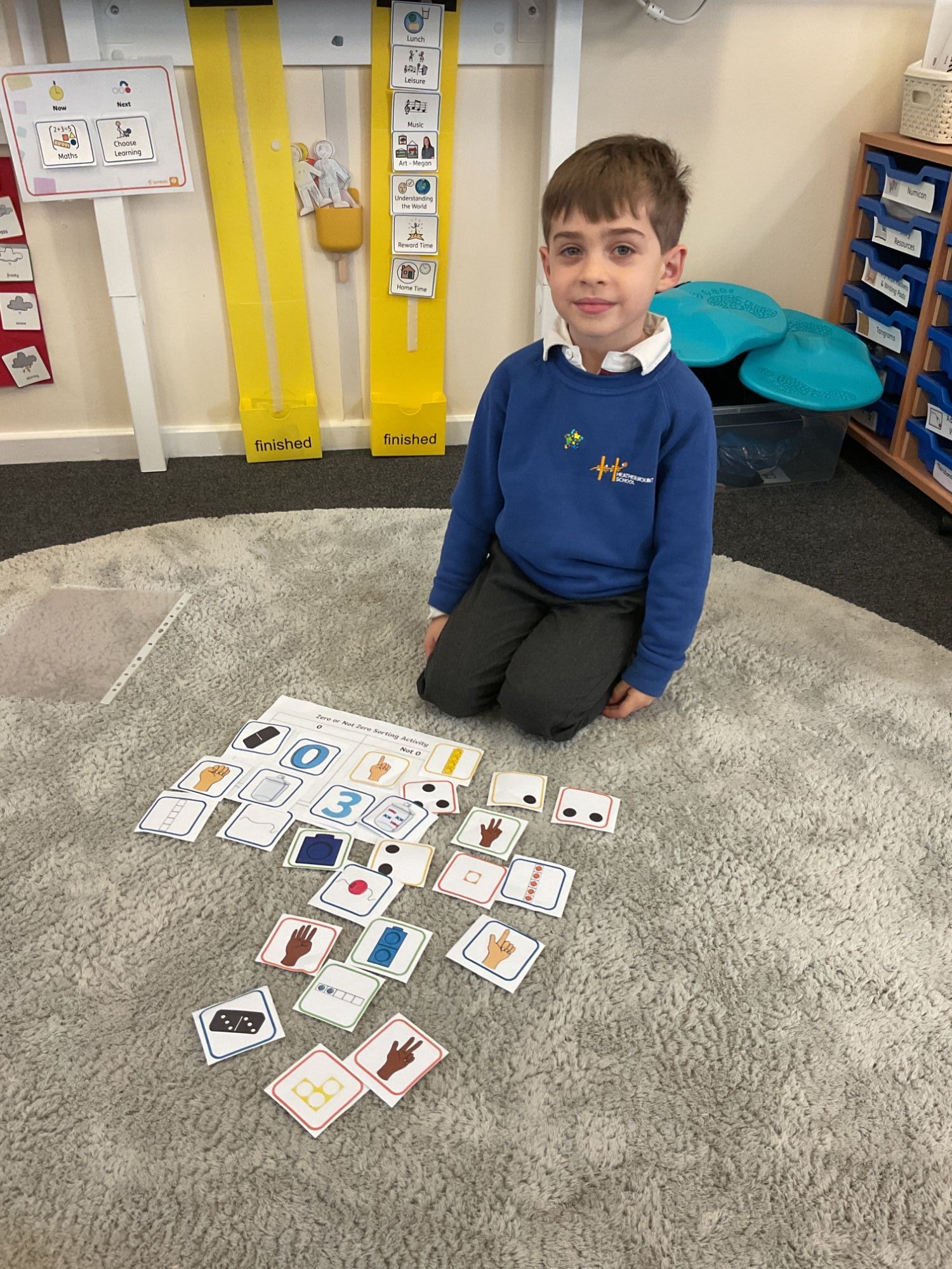 Noy sorting cards on the carpet