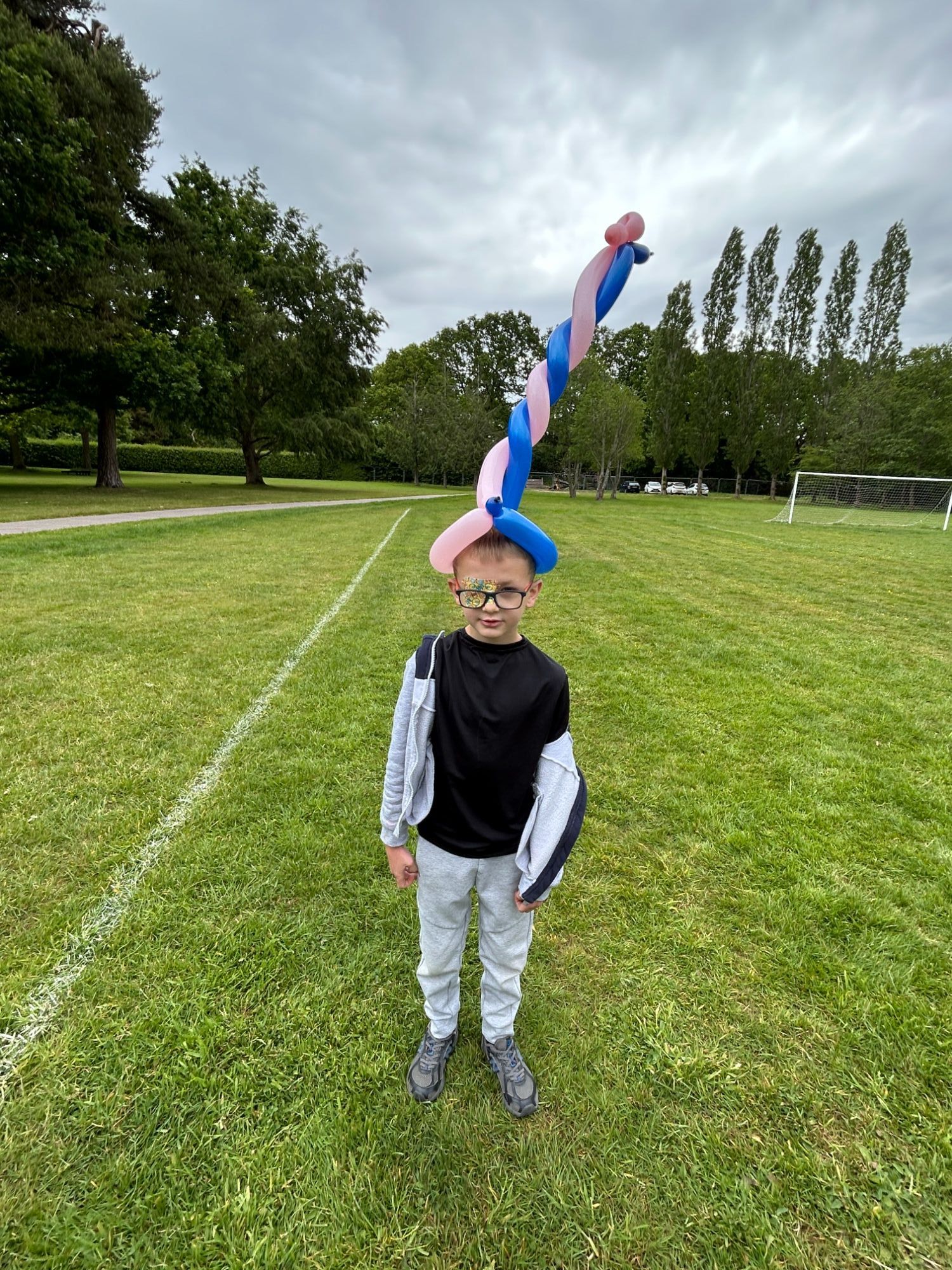 Child wearing his very tall balloon hat from the circus