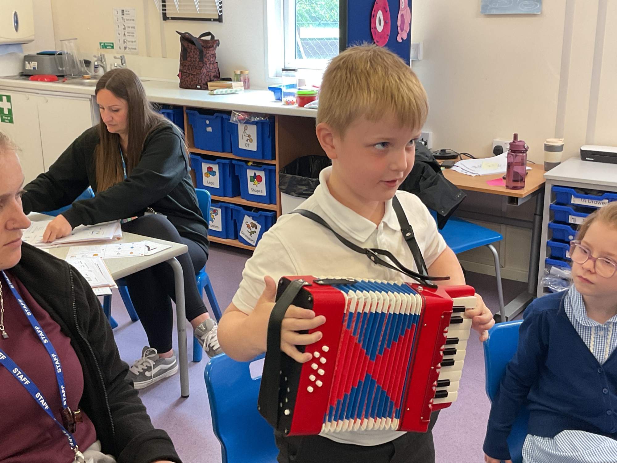 Boy playing the accordian in class