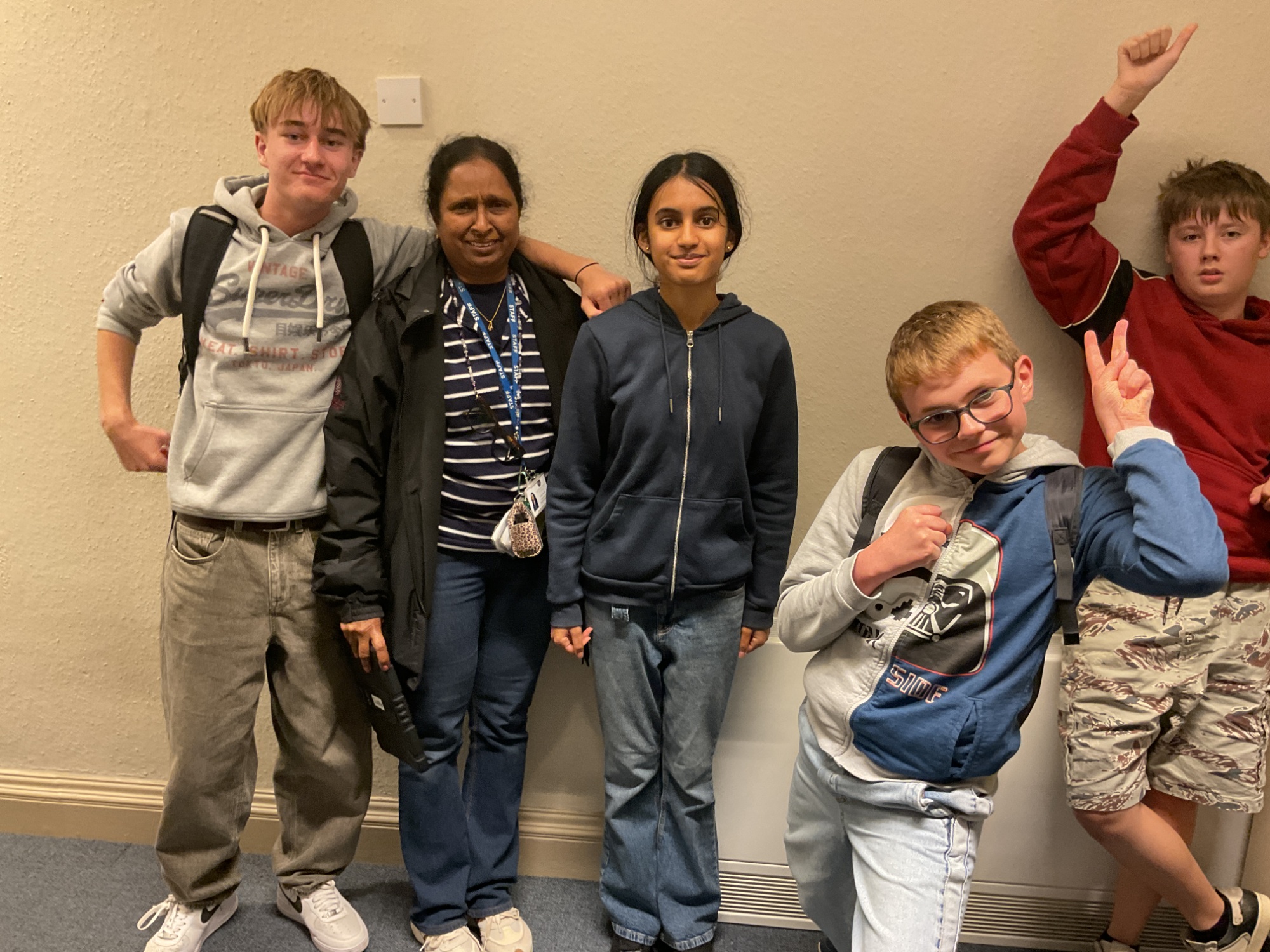 Group of students smiling in their jeans with a HLTA
