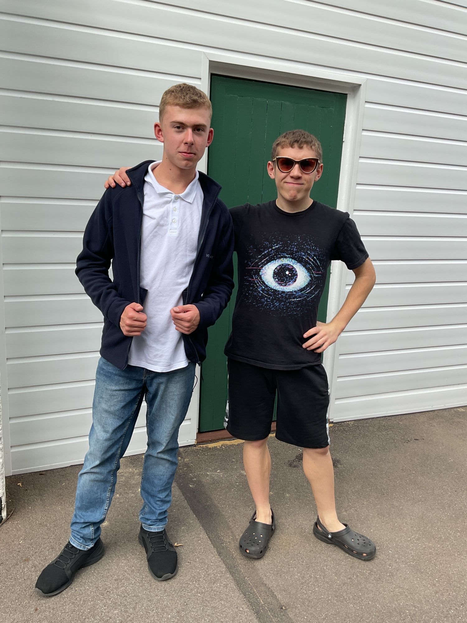 Two friends posing together in non uniform