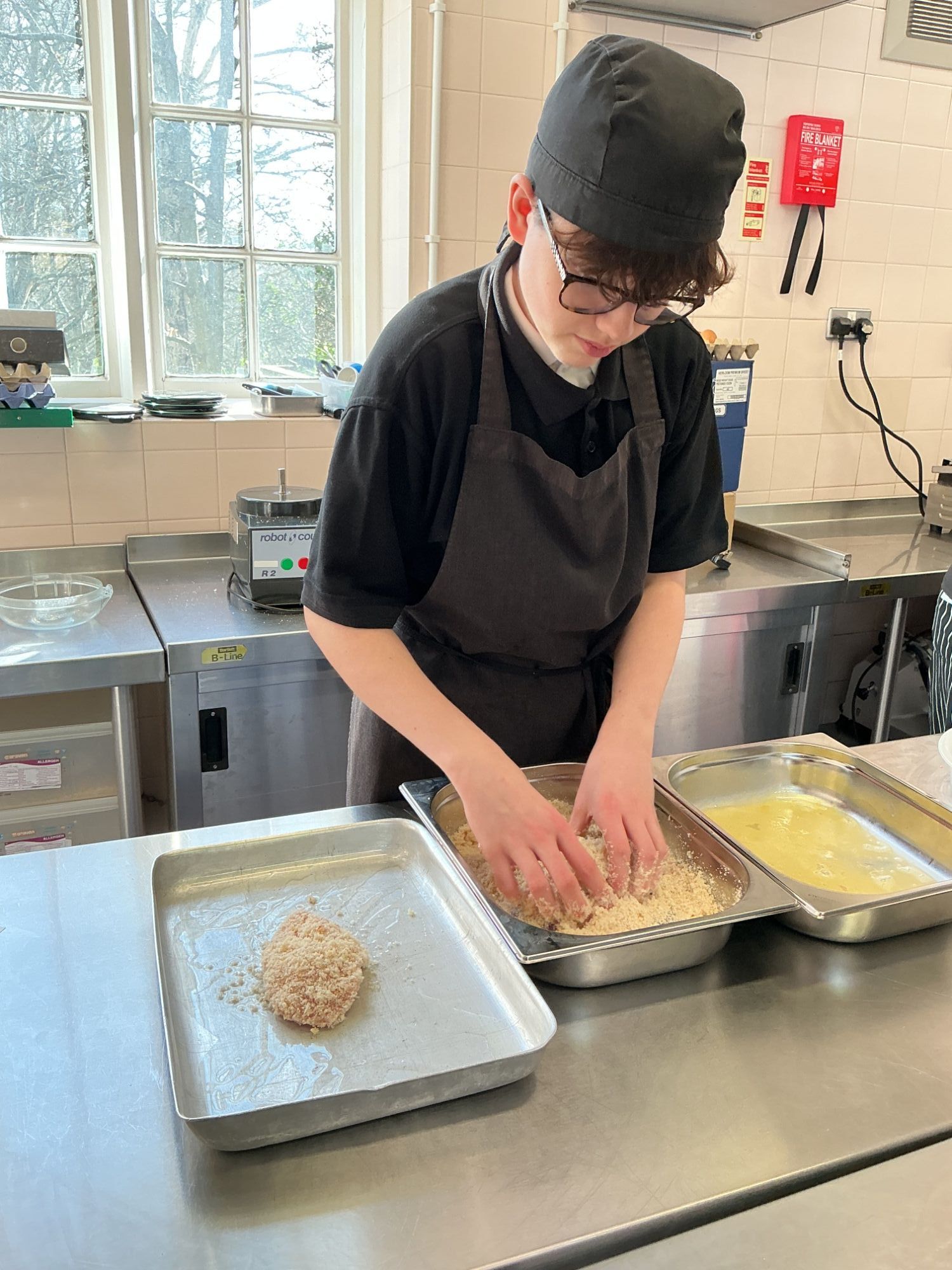 Student breading his chicken