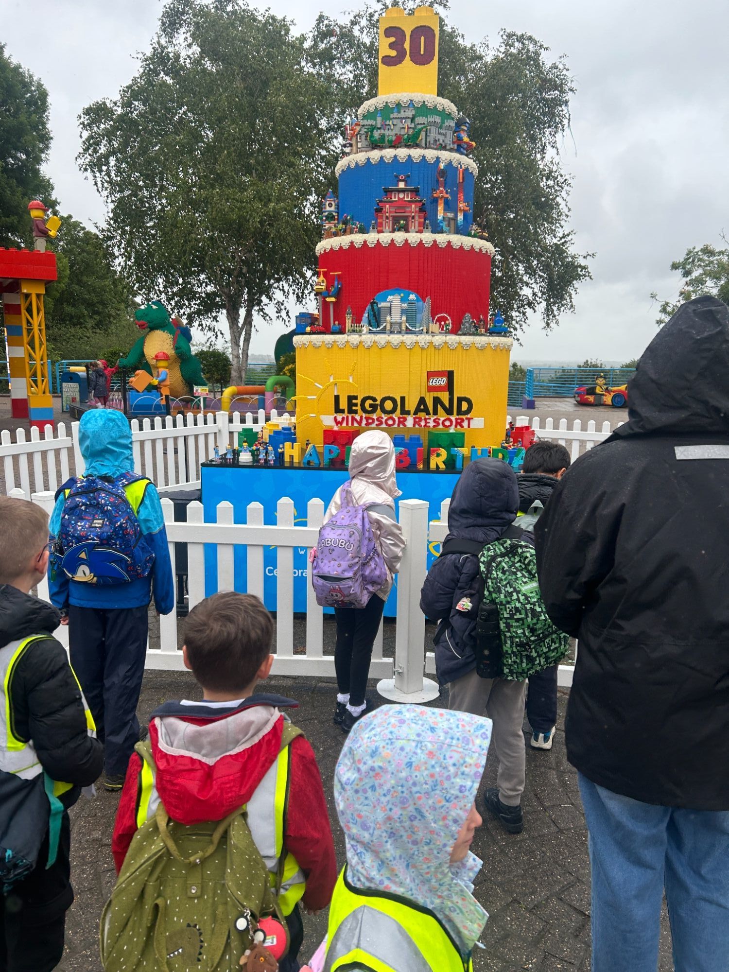 students looking at a lego tower