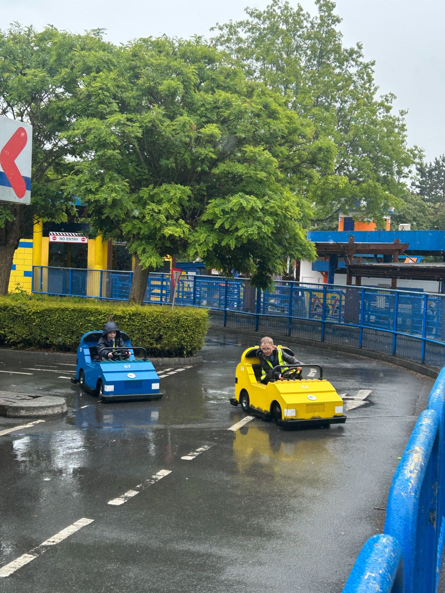 Two students driving lego cars