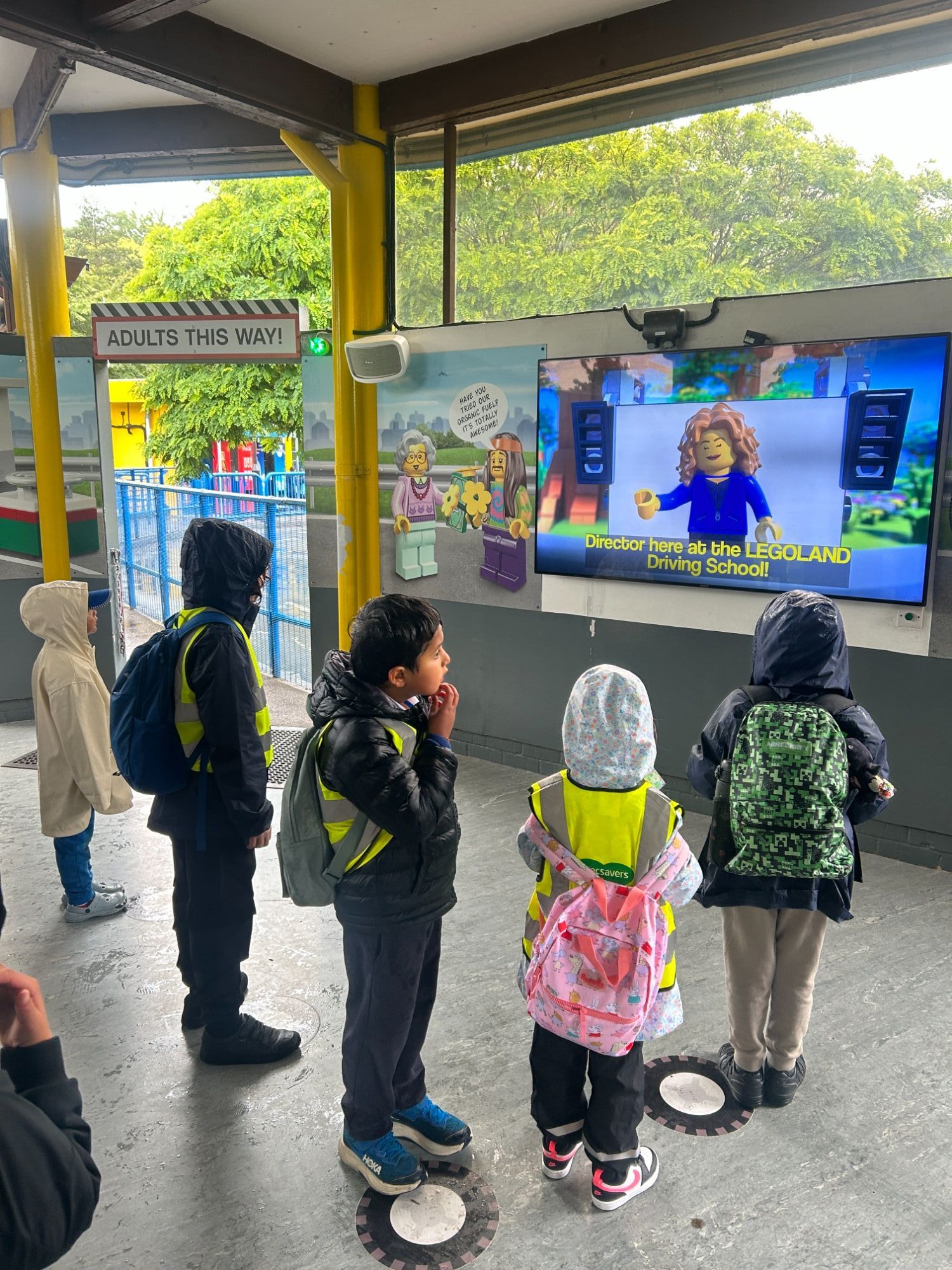 Children watching a lego animation on screen