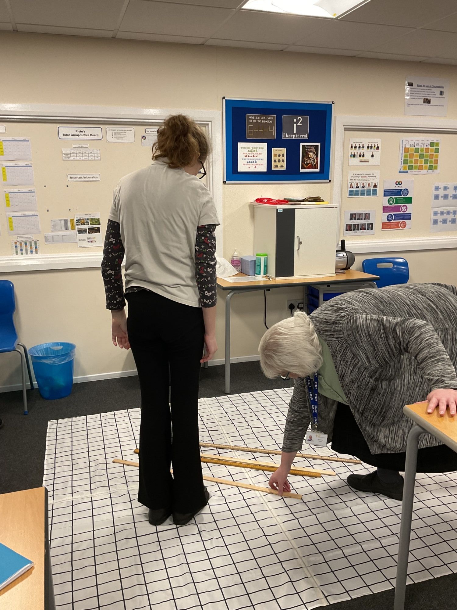 Student and teacher plotting a graph on the shower curtain