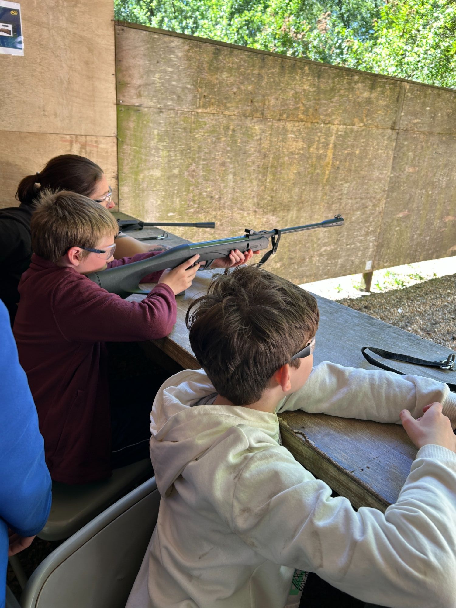 Three students using air rifles