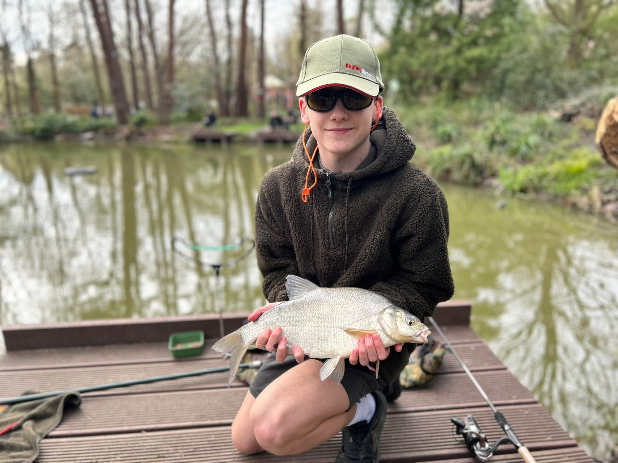 Older student with the fish he has caught