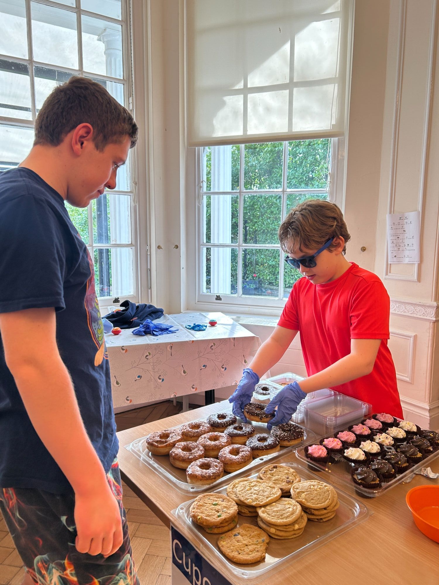 Students serving a cake