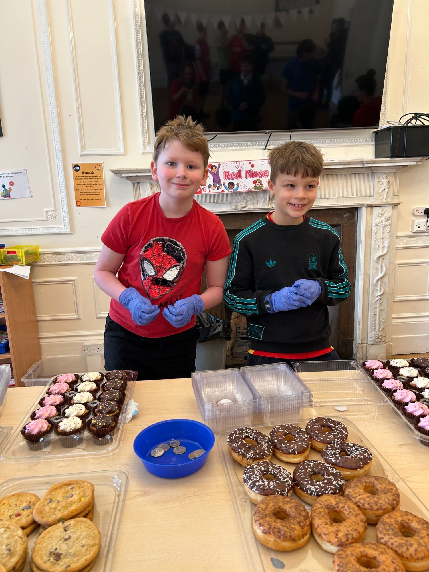 Two students ready to serve cakes