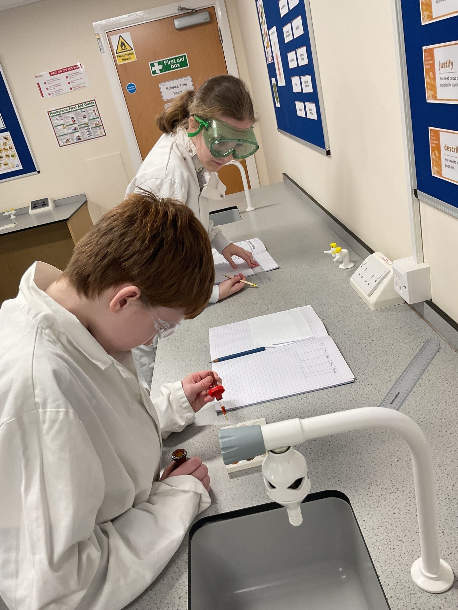 Two students recording scientific data