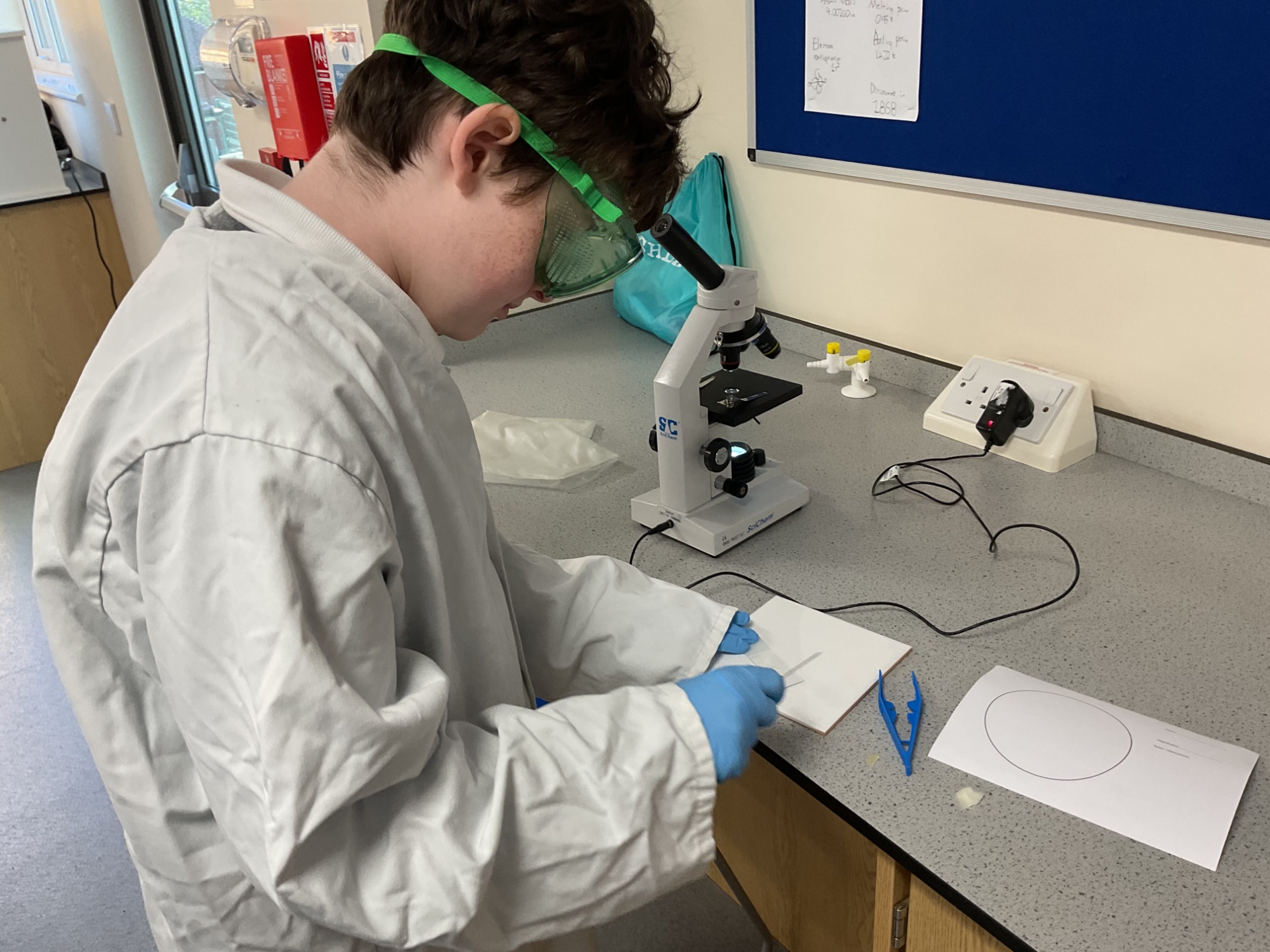 Mars student and microscope 2 Mars students working with a microscope