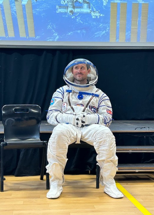 Pete wearing the full astronaut suit including helmet