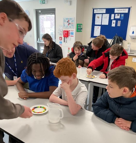 Younger students doing a science experiment