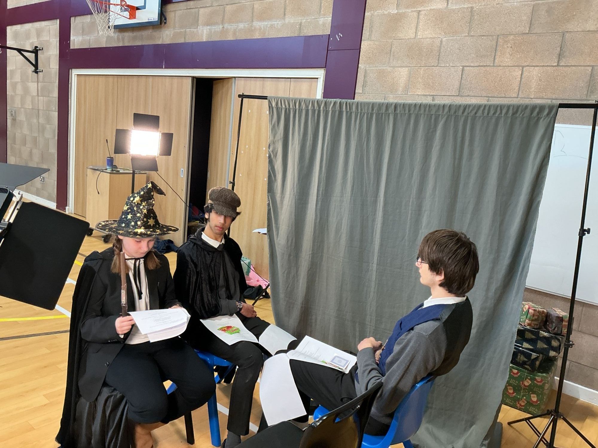 Three students running through the script in costume