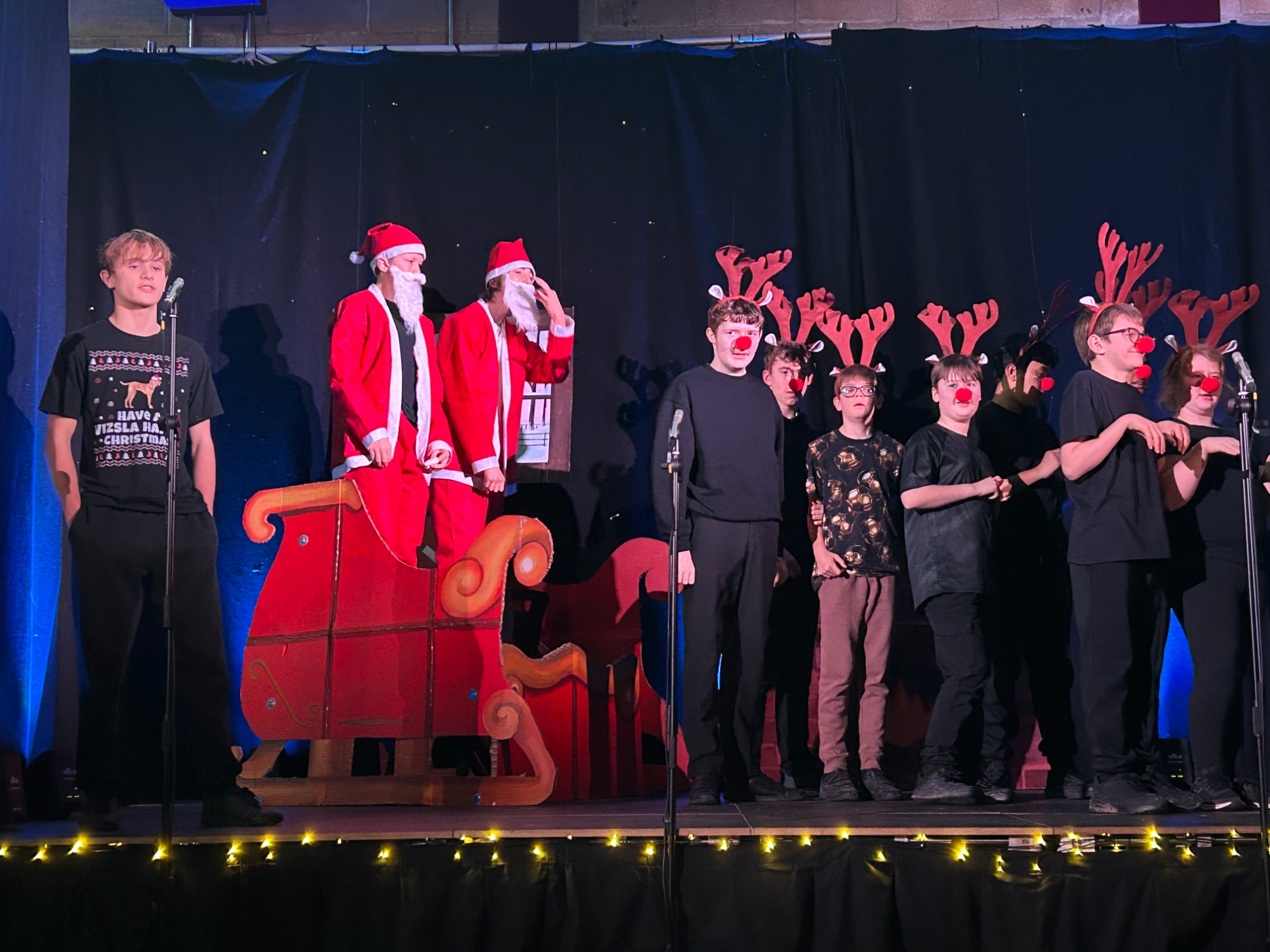 A narrator, two Santa's on their sleigh and lots of reindeer