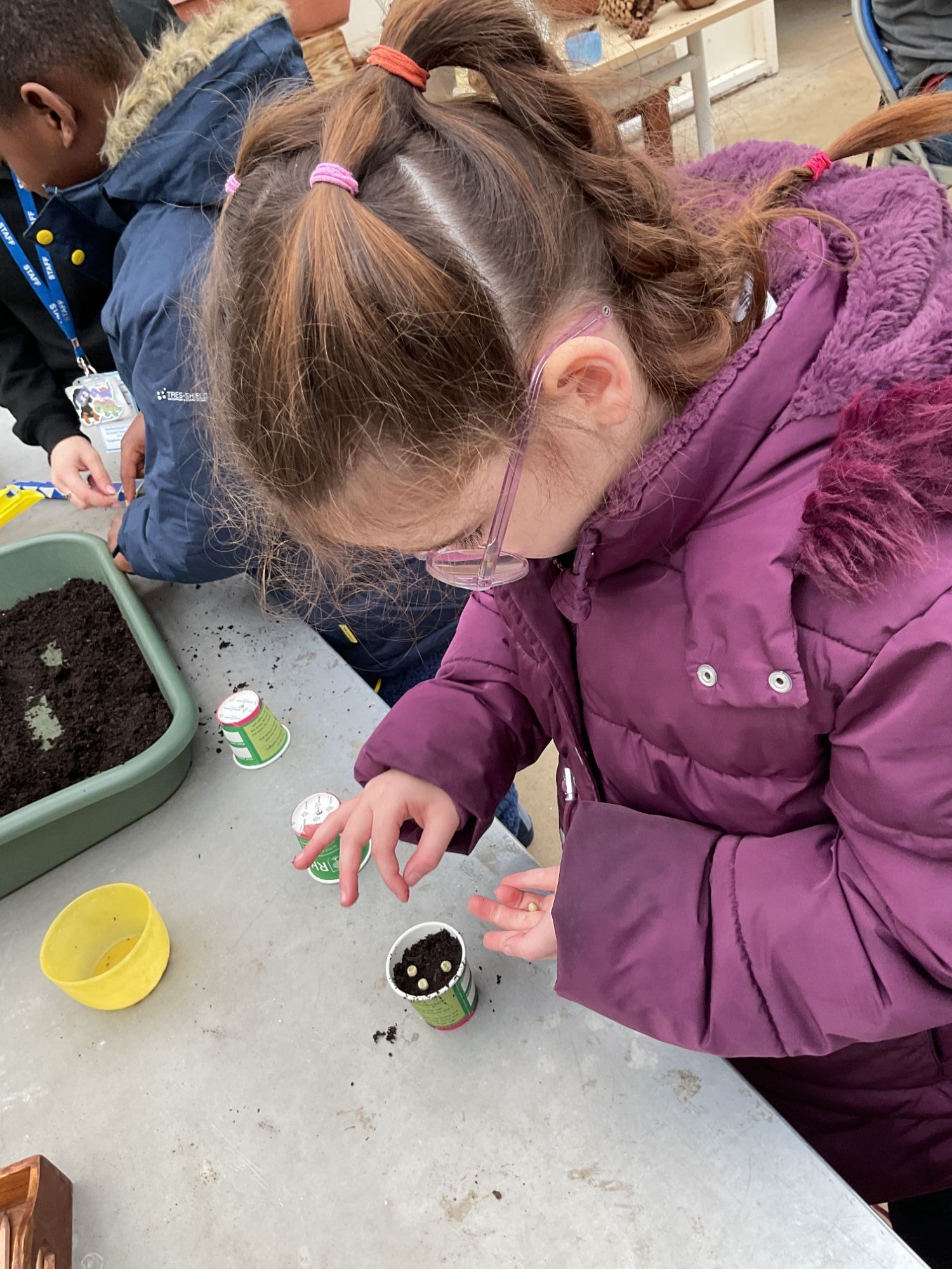 Girl planting her pea
