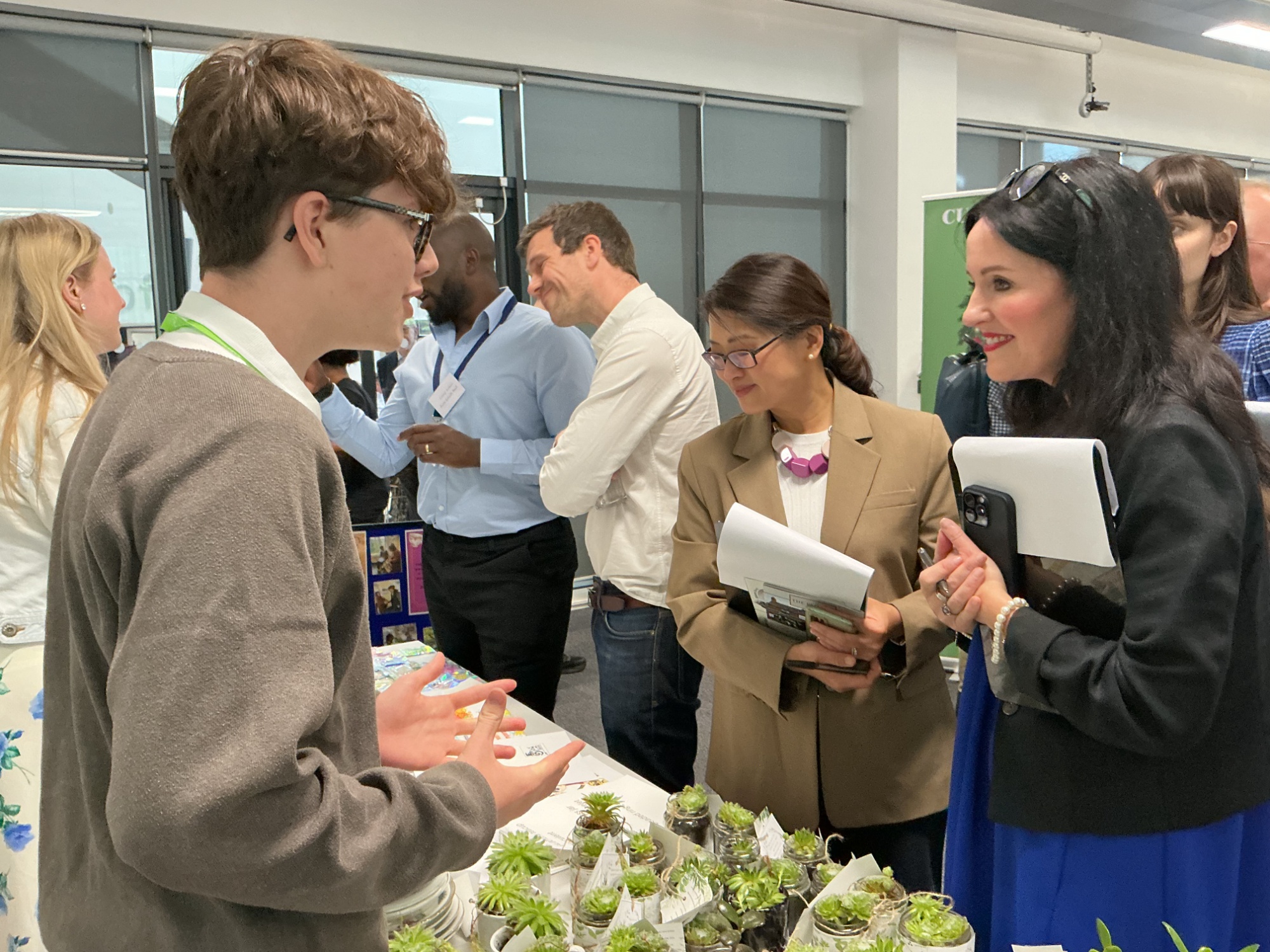 Student talking to judges at his stall