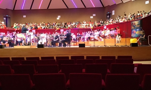 The Hexagon Theatre stage with full orchestra and audience