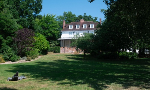 The main house at Heathermount School with the lawns and the crocodile sculpture.