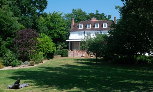 The main house at Heathermount School with the lawns and the crocodile sculpture.