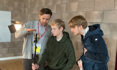Alex advising two students on filming