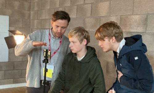 Alex advising two students on filming