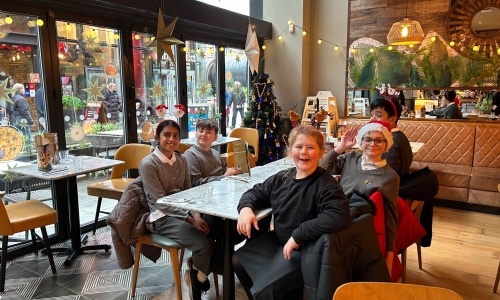 Earth class sitting down for their meal at Pizza Express