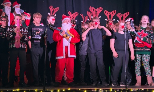 All the students on stage in costume dancing to the final song.
