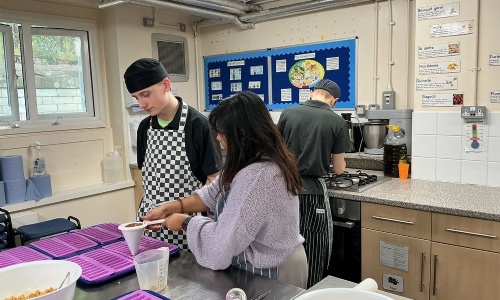 Young Enterprise student pouring chocolates into moulds for the Young Enterprise project