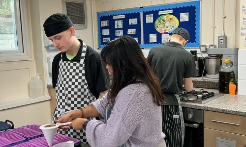 Young Enterprise student pouring chocolates into moulds for the Young Enterprise project