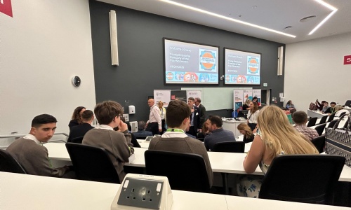 Students sat in alecture hall looking at the Young Enterprise speakers on stage