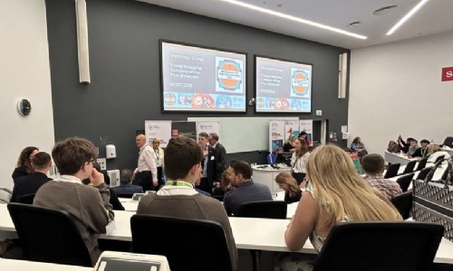 Students from team Juto listening to a presentation from Young Enterprise in a lecture theatre